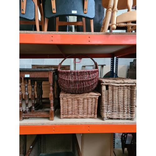 348 - An oak nest of three tables and three various wicker baskets