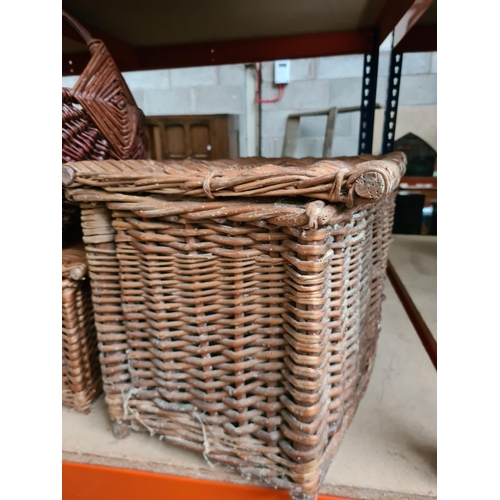 348 - An oak nest of three tables and three various wicker baskets