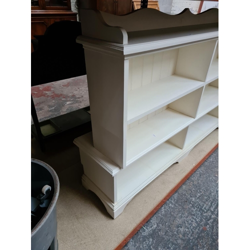 353 - A white painted six section freestanding bookcase