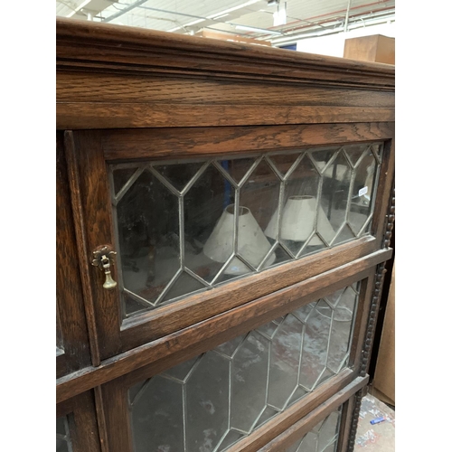 361 - An early 20th century Simpoles Chapter oak and leaded glass three section stacking bookcase - approx... 