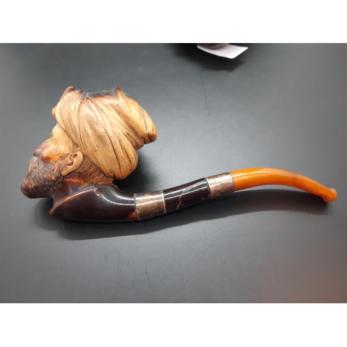 37 - A 19th century leather cased Meerschaum pipe with amber mouthpiece and white metal collars