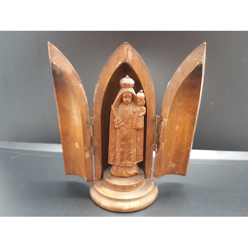 38 - Two items, a brass matchbox holder and a small carved wooden concealed religious figurine