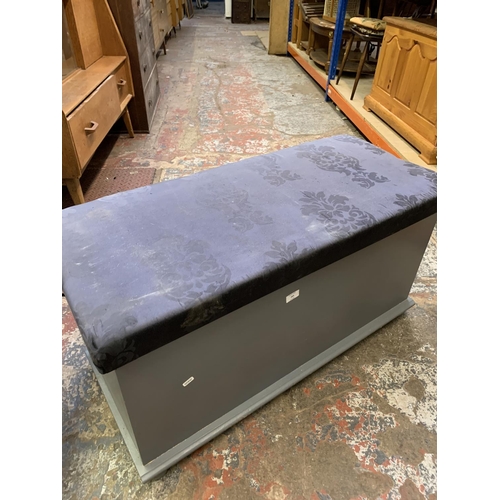 389 - A modern grey painted blanket box with blue floral upholstery