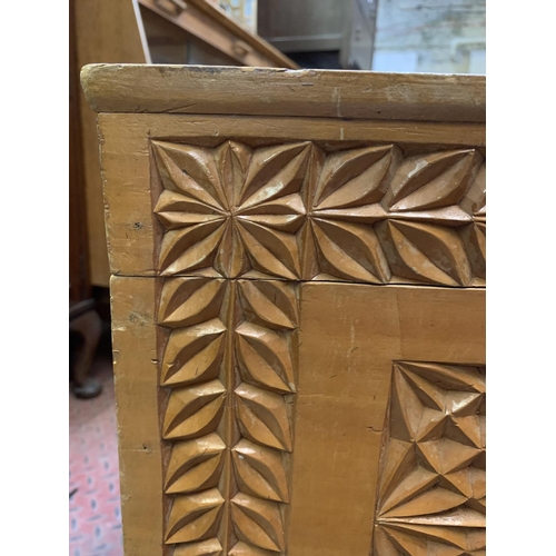 395 - Two items, a camphor wood carved blanket chest together with a beech rocking chair