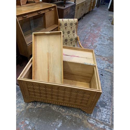 395 - Two items, a camphor wood carved blanket chest together with a beech rocking chair