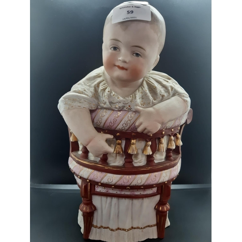 59 - A 19th century continental bisque porcelain figurine of a baby on Victorian chair - approx. 34cm hig... 