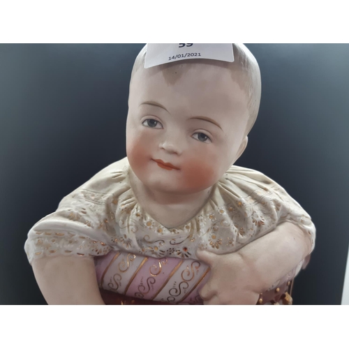 59 - A 19th century continental bisque porcelain figurine of a baby on Victorian chair - approx. 34cm hig... 