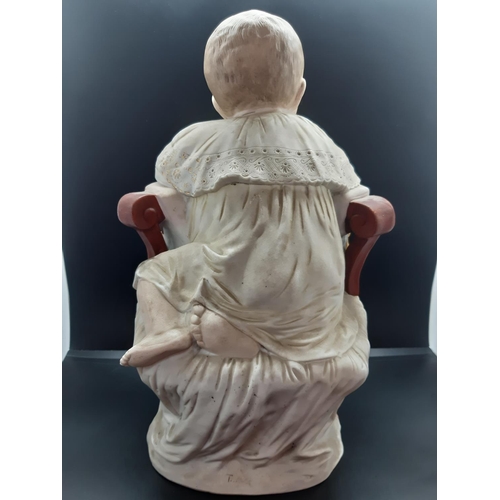 59 - A 19th century continental bisque porcelain figurine of a baby on Victorian chair - approx. 34cm hig... 