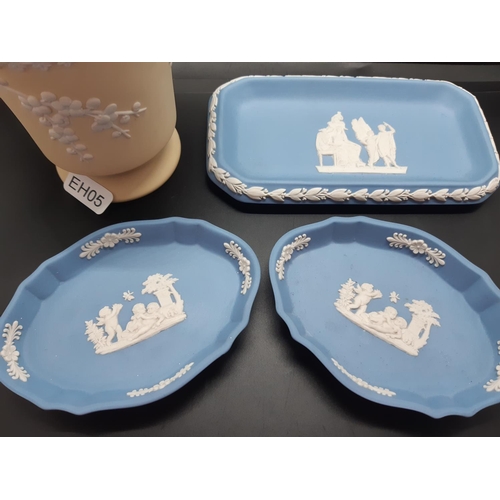 60 - Four pieces of Wedgwood Jasperware to include three pale blue trinket dishes and one yellow vase - a... 