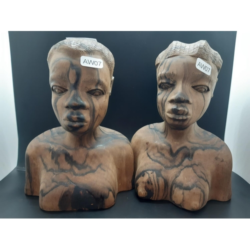 68 - A pair of mid/late 20th century carved lignum vitae African busts - approx. 21cm high