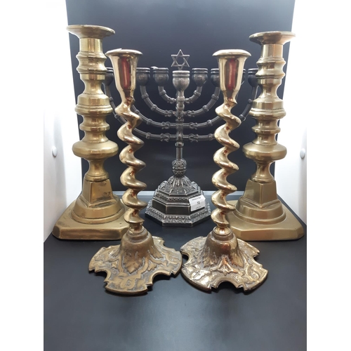 72 - Five items, a vintage Ian Heath Ltd. Ianthe silver plated menorah, pair of Georgian solid brass cand... 