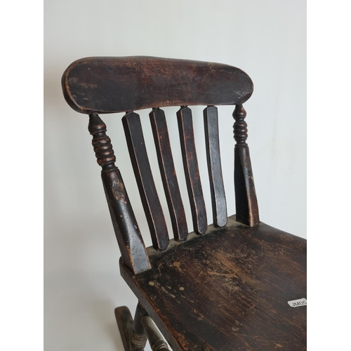 79 - A Victorian elm and beech child's rocking chair - approx. 60cm high