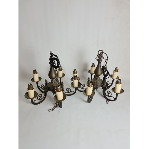 82 - A pair of antique style brass five branch chandeliers