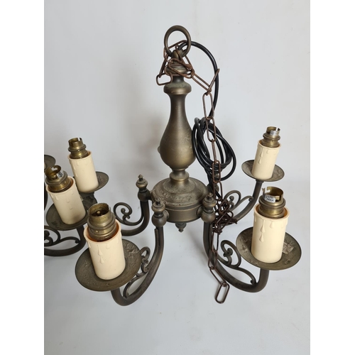 82 - A pair of antique style brass five branch chandeliers