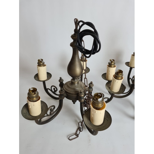 82 - A pair of antique style brass five branch chandeliers