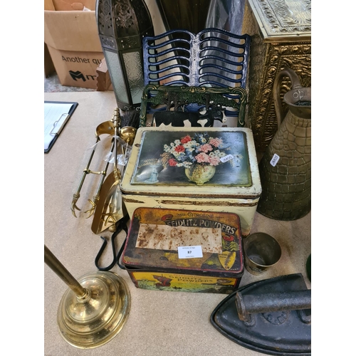 87 - Assorted metalware to include embossed brass coal box, vintage tins, brass umbrella stand, cast iron... 