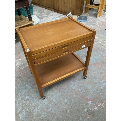 413 - A mid 20th century teak two tier tea trolley