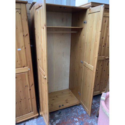 421 - A modern pine double wardrobe