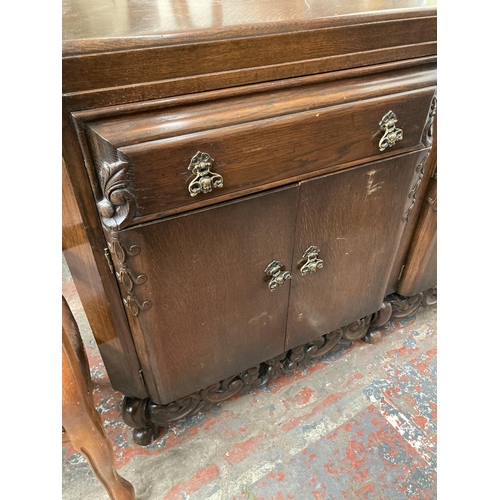 431 - An early 20th century carved oak sideboard