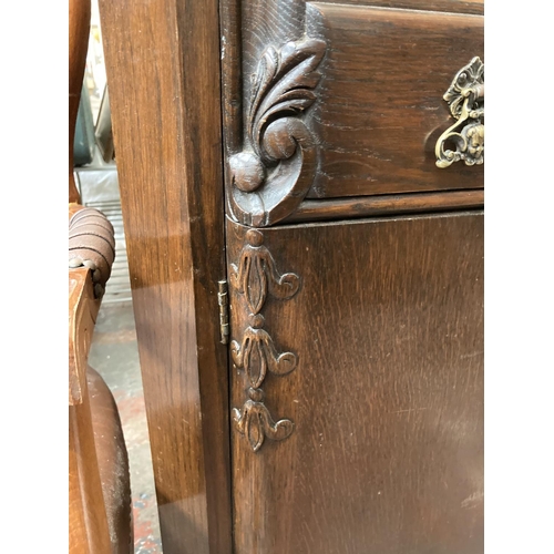 431 - An early 20th century carved oak sideboard