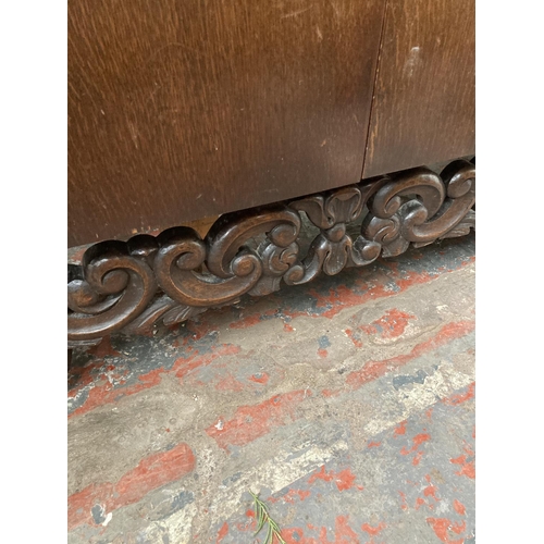 431 - An early 20th century carved oak sideboard