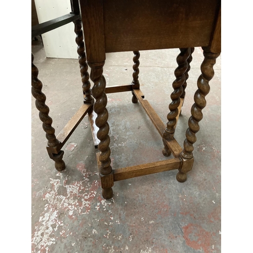 471 - An early 20th century oak drop leaf gate leg dining table on barley twist supports with pie crust ed... 