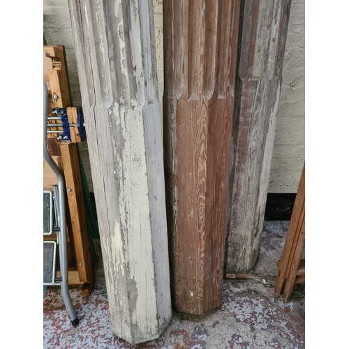 1080 - Three 19th century carved pitch pine corinthian columns to include two - approx. 9' high x 10