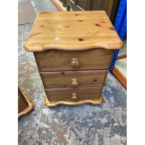 352 - A pair of modern pine three drawer bedside cabinets