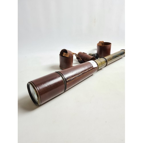 74 - A WW1 period brass three drawer military signalling telescope with brown leather cover by Dollond of... 