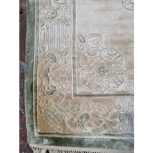 204B - A small Chinese silk rug - approx. 118cm long and 61cm wide