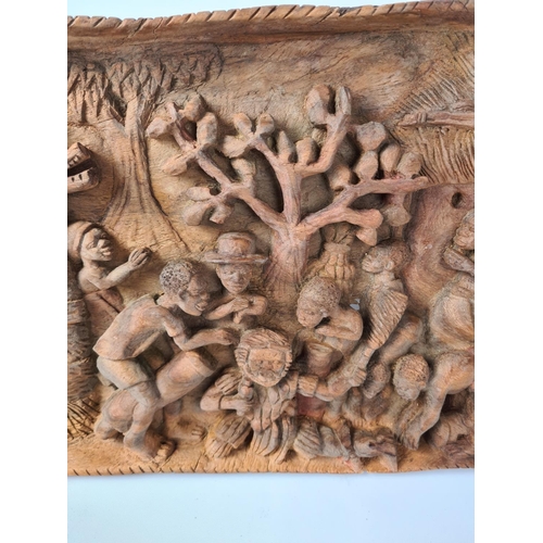 100 - A vintage African carved teak wall plaque with tribal relief - approx. 68cm wide x 32cm high