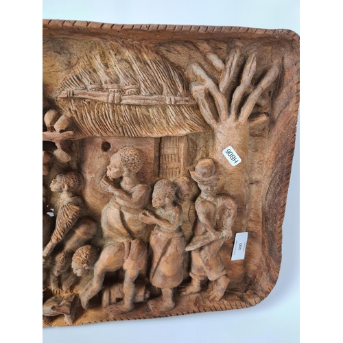 100 - A vintage African carved teak wall plaque with tribal relief - approx. 68cm wide x 32cm high