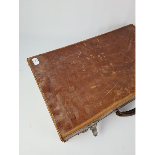 101 - A vintage brown leather suitcase - approx. 61cm wide x 35cm deep x 11cm high