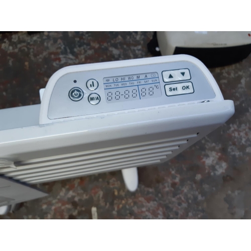 1065 - A Devola electric convector heater with digital timer and instruction manual