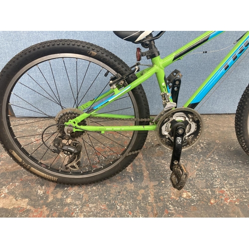 1100 - A green Trek boy's stunt bike with front suspension and 21 speed Shimano gear system