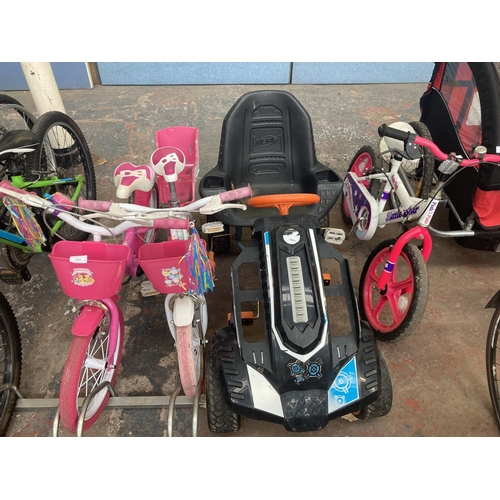 1101 - Four items, one pink and white Little Star Pedal Pals BMX, one black Nerf Battle pedal car, one pink... 