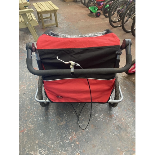 1102 - A black red and grey 2-in-1 two seat child's covered bike trailer/pushchair with suspension and brak... 