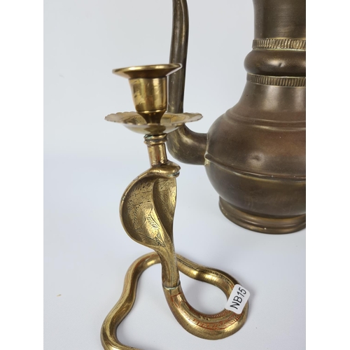 113 - Three pieces of brassware to include a pair of serpent candlesticks and a middle eastern coffee pot