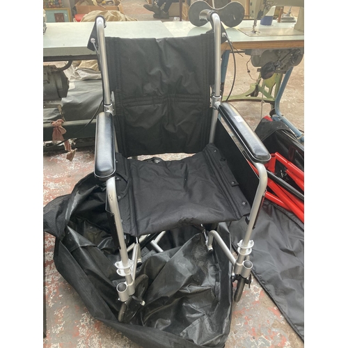 1131 - A bagged black and grey Traveller folding wheelchair