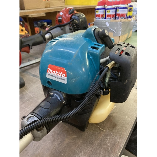 1216 - A black and blue Makita long reach petrol hedge trimmer with 20