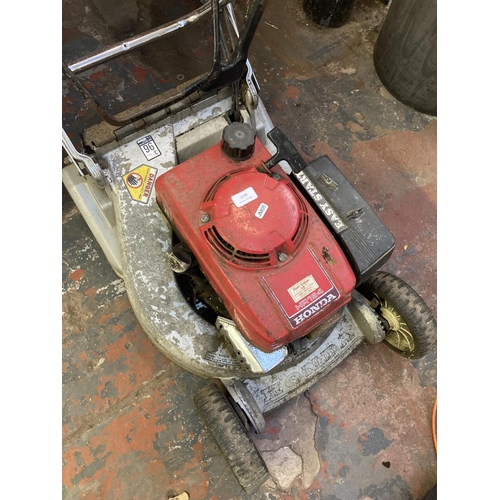 1238 - Two petrol lawnmowers, one red and grey Honda HR194 and one black and red Sovereign XS240