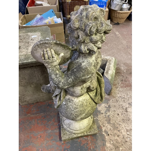 1239 - An early/mid 20th century cast stone cherub playing cymbals garden ornament on three piece column ba... 