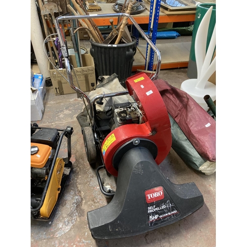 1243 - A black and red Toro 5hp self propelled petrol leaf blower/vacuum with collection bag