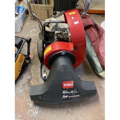 1243 - A black and red Toro 5hp self propelled petrol leaf blower/vacuum with collection bag