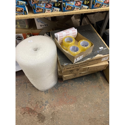 1260 - A mixed lot, 4 packs of 20 50cm x 50cm grey carpet tiles, one roll of bubble wrap, six rolls of pack... 