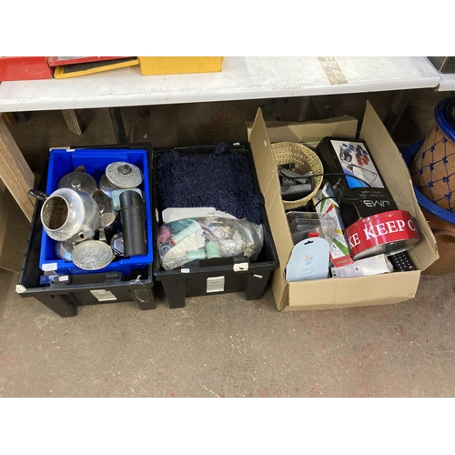 1264 - Four boxes containing stainless steel teapots, books, sewing equipment, clothing etc.