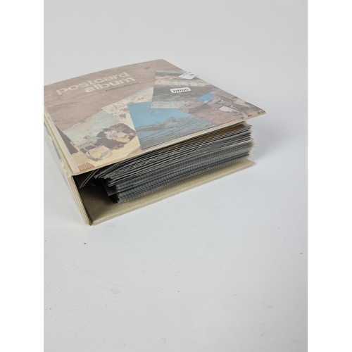 128 - A postcard album containing a large quantity of postcards