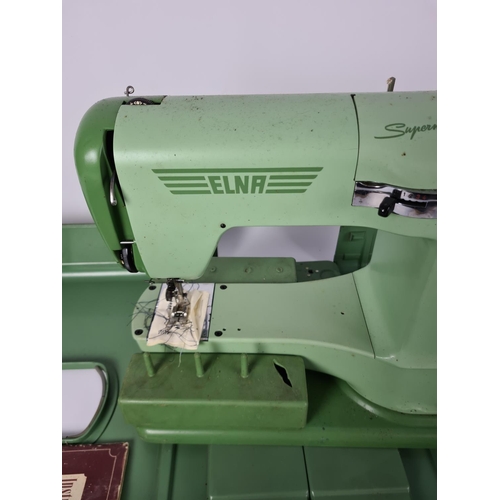 131 - A cased vintage green Elna Supermatic electric sewing machine