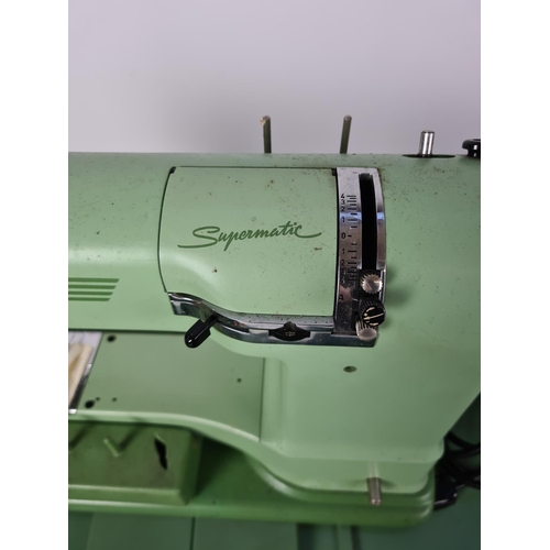 131 - A cased vintage green Elna Supermatic electric sewing machine