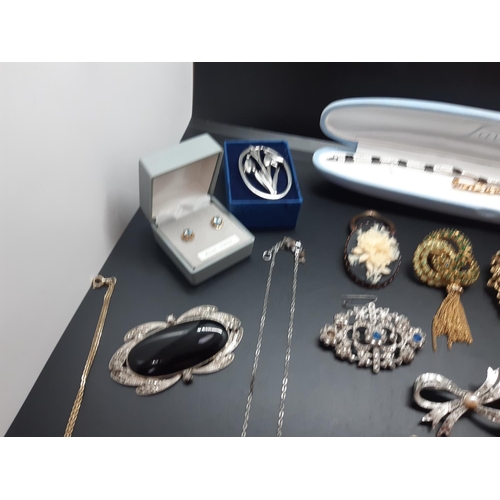 14 - A collection of vintage costume jewellery to include a hallmarked 925 silver cross with inset faux d... 